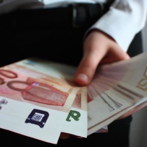 Person holding money and documents